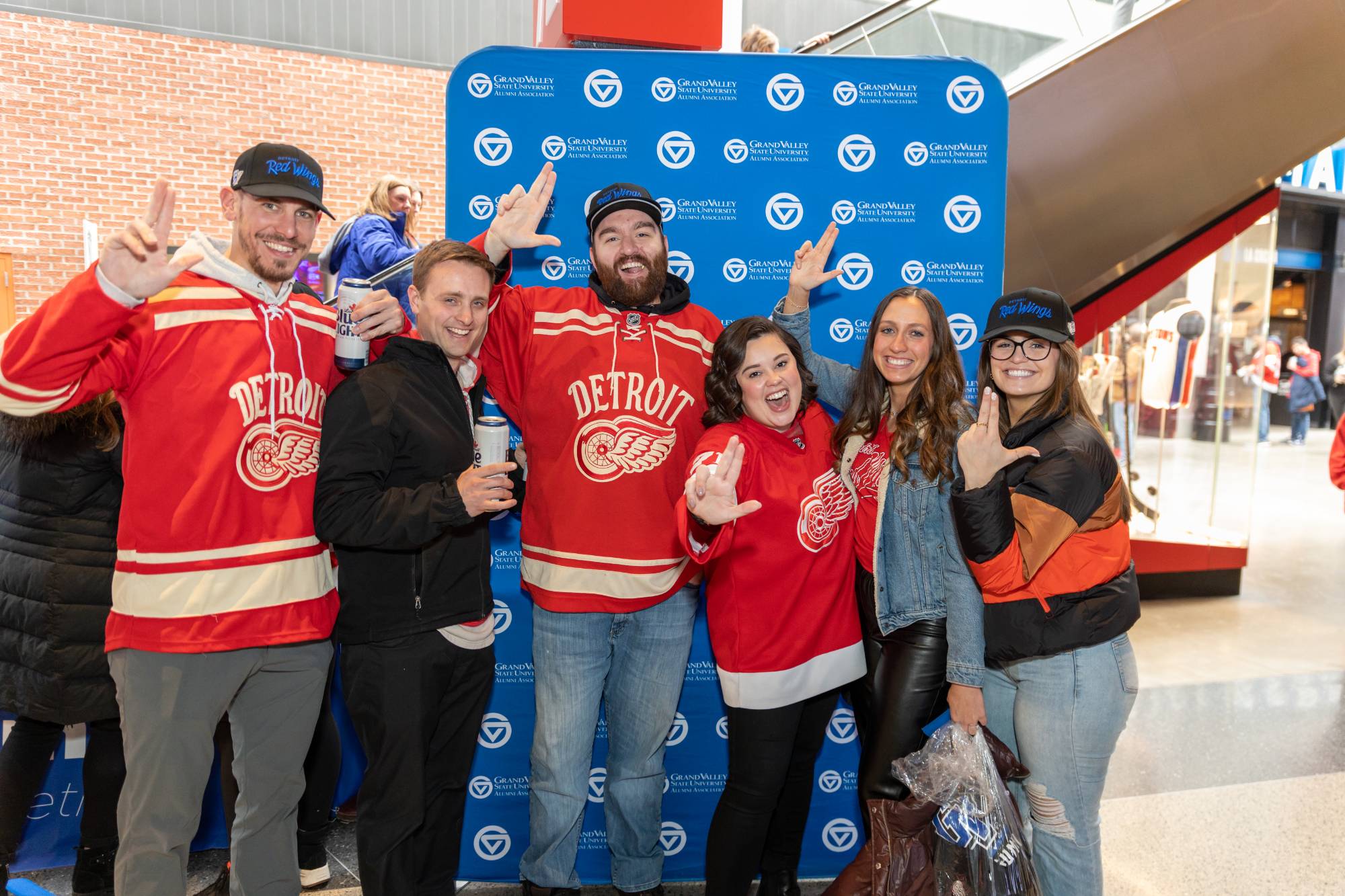 A group of alumni pose for a photo at a Red Wings game